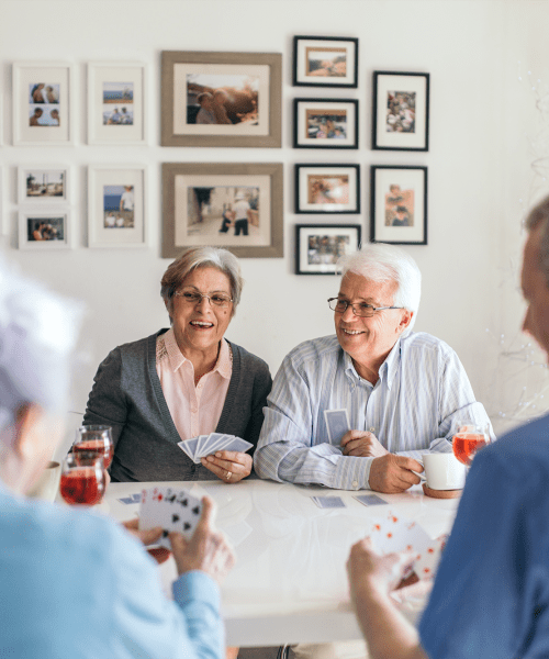 2 friendly couples playing a game of cards at Traditions of Lansdale in Lansdale, Pennsylvania