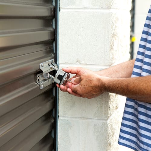 A customer locks a storage unit at Red Dot Storage in Richton Park, Illinois