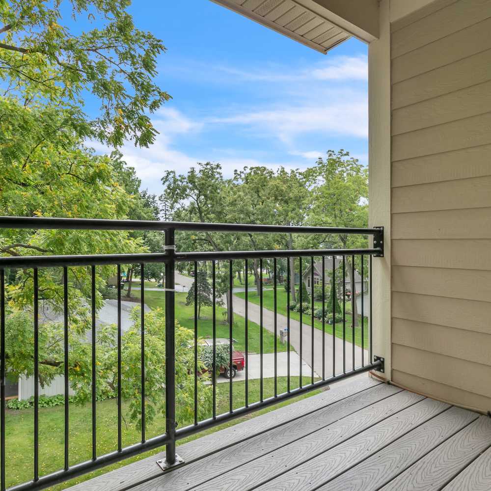Private patio with railing and view of community at Residences on Main in Twin Lakes, Wisconsin