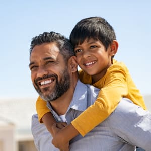 Happy resident father and son outside their new home at Vista Park in Dallas, Texas