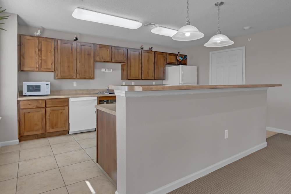 Community kitchen with storage space and raised countertop at River Ridge in Sand Springs, Oklahoma