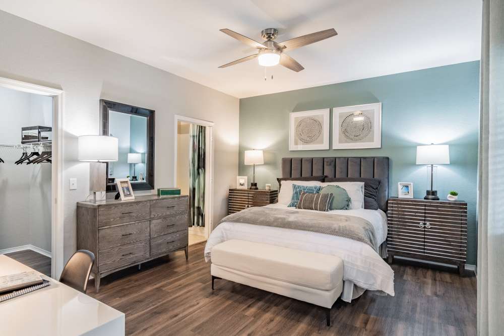 Spacious apartment bedroom with hardwood floors and walk-in closet at The Parq at Cross Creek in Tampa, Florida