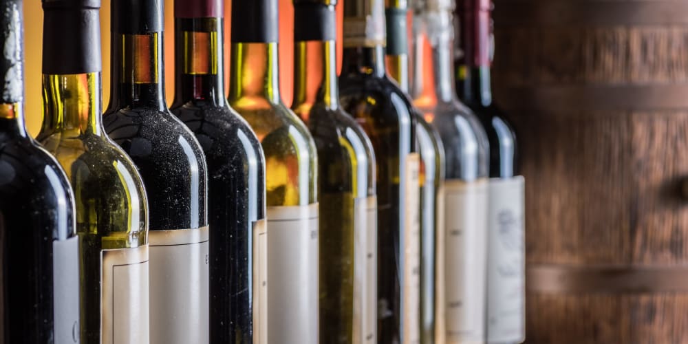 A row of red and white wines in bottles at Collection 55 Cellars in Redwood City, California