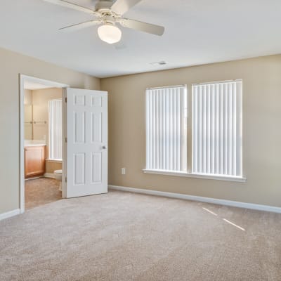 A well-lit bedroom in a home at The Village at Whitehurst Farm in Norfolk, Virginia