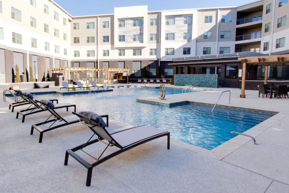 Lounge chairs and pergola by the swimming pool at Argon in Oklahoma City, Oklahoma