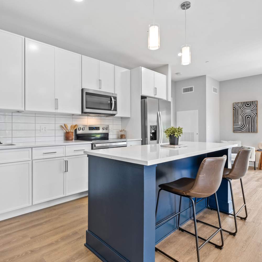 Modern kitchen and lounge area with seating and large windows at Landmark at Dublin in Dublin, Pennsylvania
