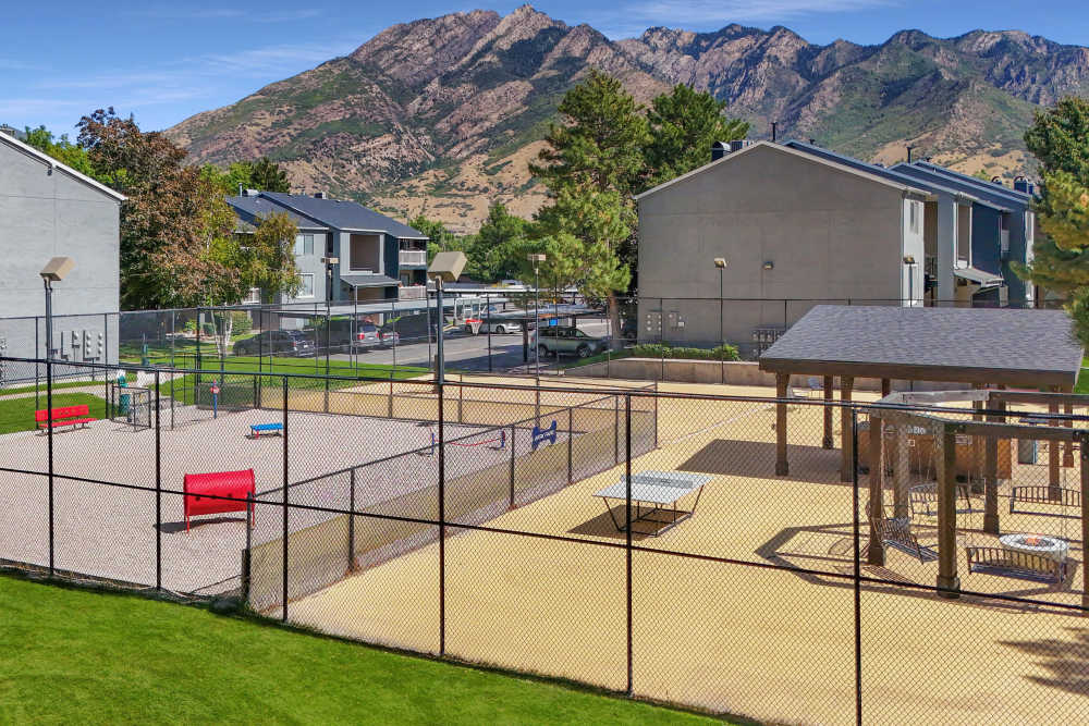 The off-leash dog park for your furry friends and barbeque area at Royal Farms Apartments in Salt Lake City, Utah