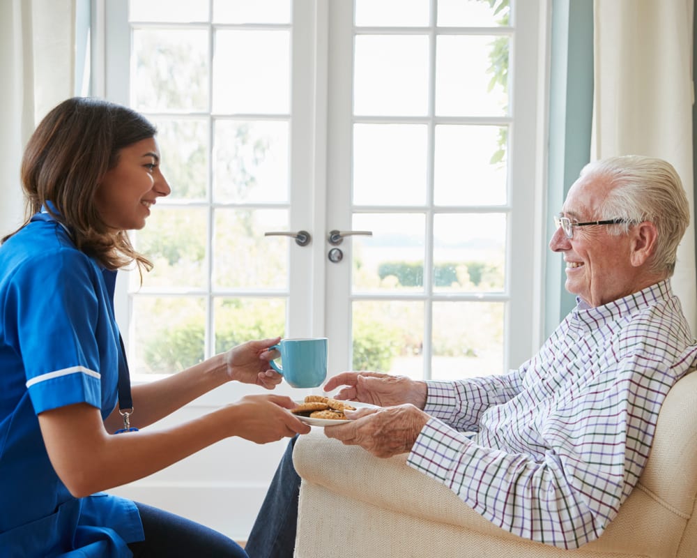 Staff brings a resident in assisted living a snack at Lawton Senior Living in Lawton, Iowa.