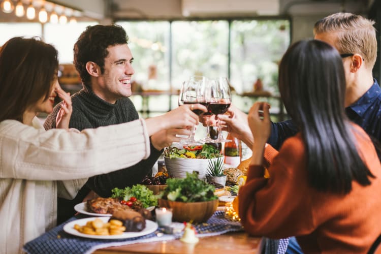 Friends enjoying dinner and wine together near Ridgeview Place in Irving, Texas