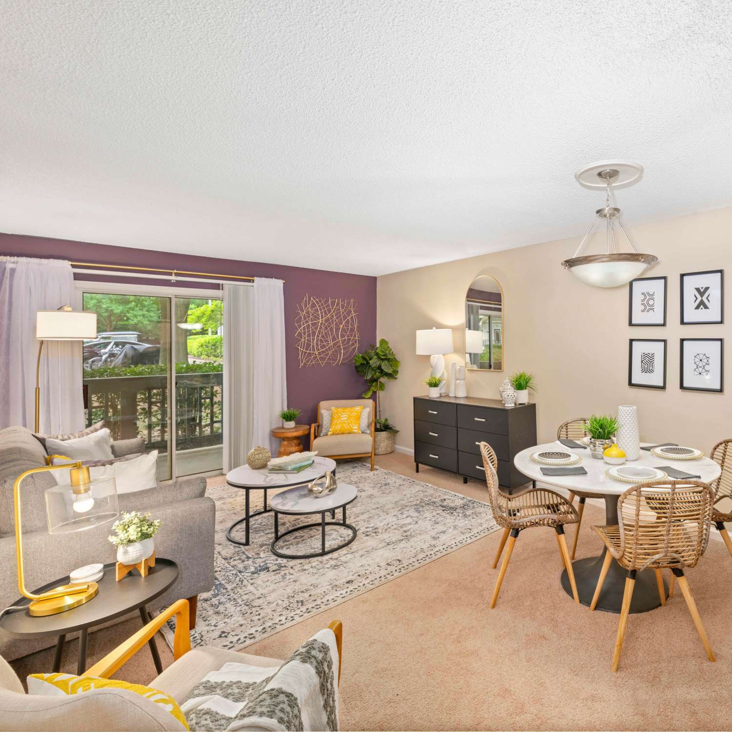 Spacious living room with large window and access to dining area at The Ellery of Cary in Cary, North Carolina