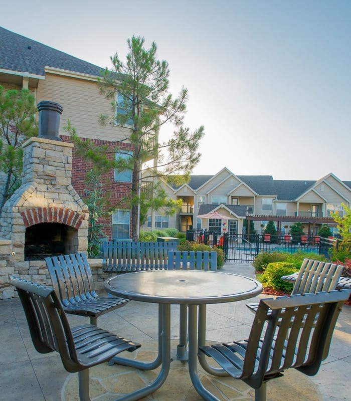 Outdoor seating with fireplace at Nickel Creek Apartments in Tulsa, Oklahoma