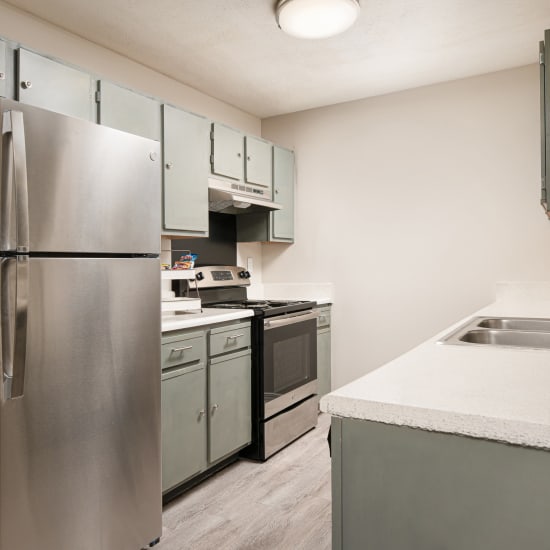 An apartment kitchen with stainless-steel appliances at Midsouth 301 in Jackson, Mississippi