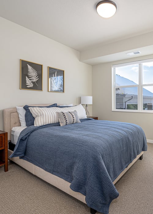 Furnished apartment bedroom with large window at The Pillars of Grand Rapids in Grand Rapids, Minnesota