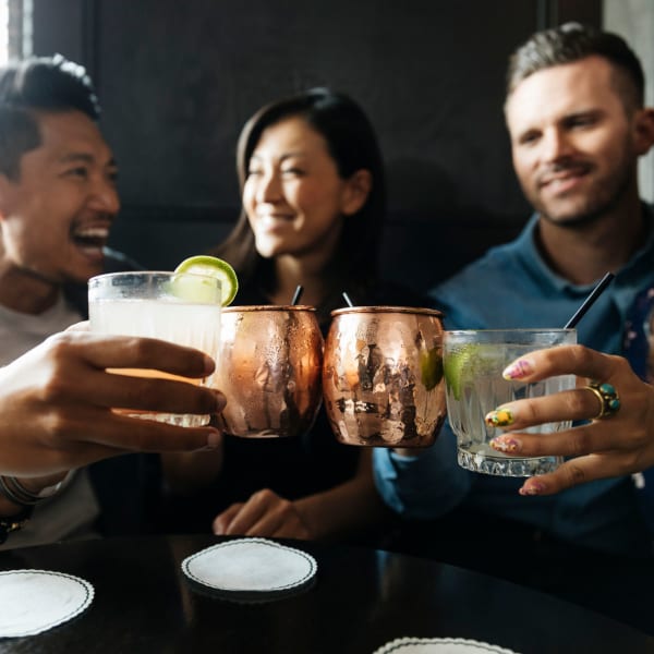 Residents socializing with their drinks at Crystal Springs in Fort Worth, Texas