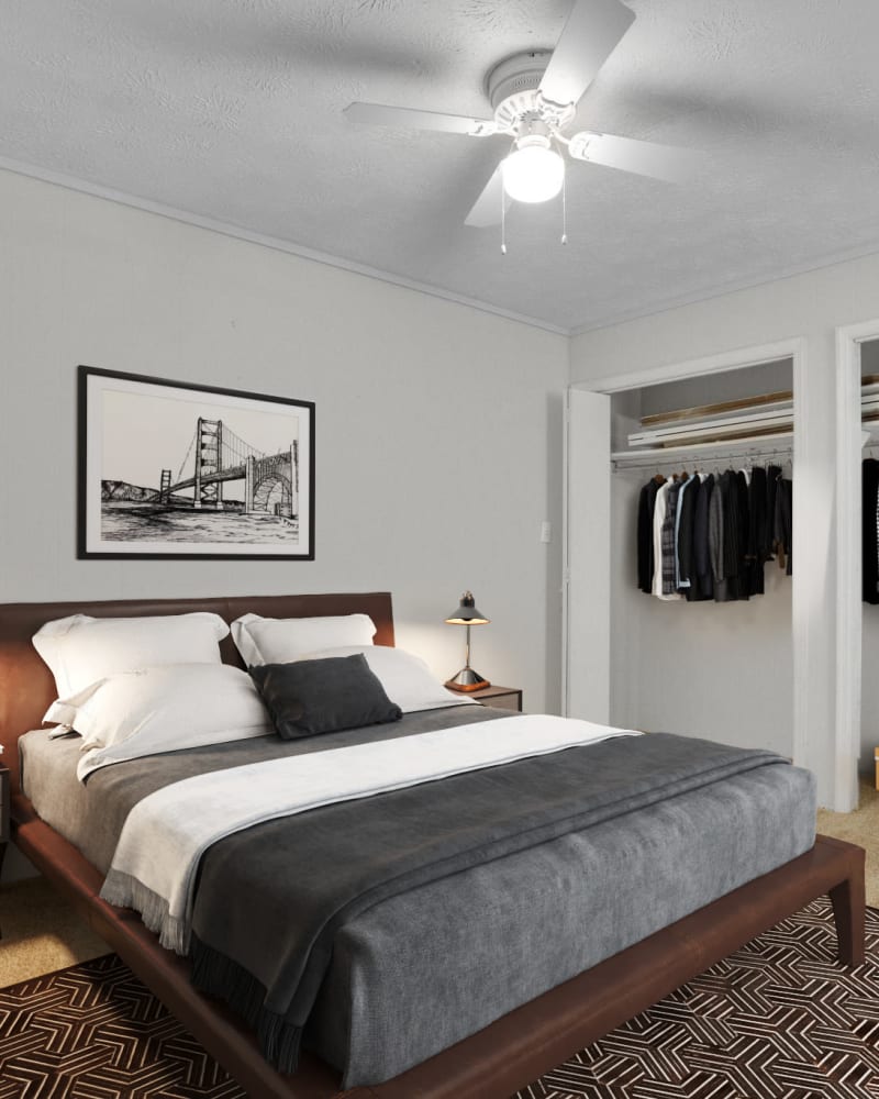 An apartment bedroom with the closet doors open at Briarcliff Apartment Homes in Milledgeville, Georgia at dusk