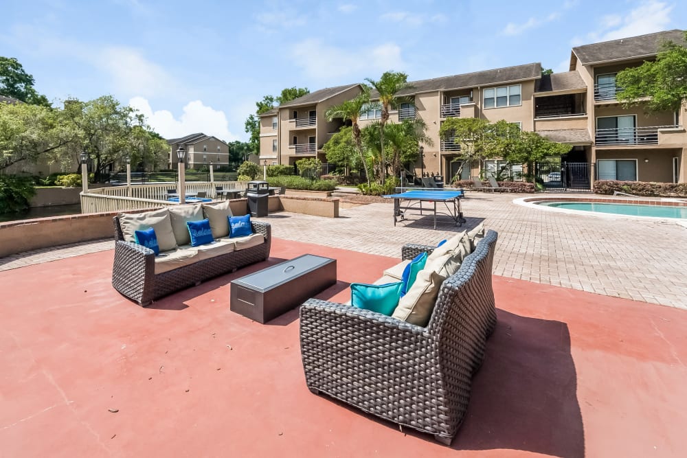 Outdoor lounge area and ping pong table at Tuscany Pointe at Tampa Apartment Homes in Tampa, Florida