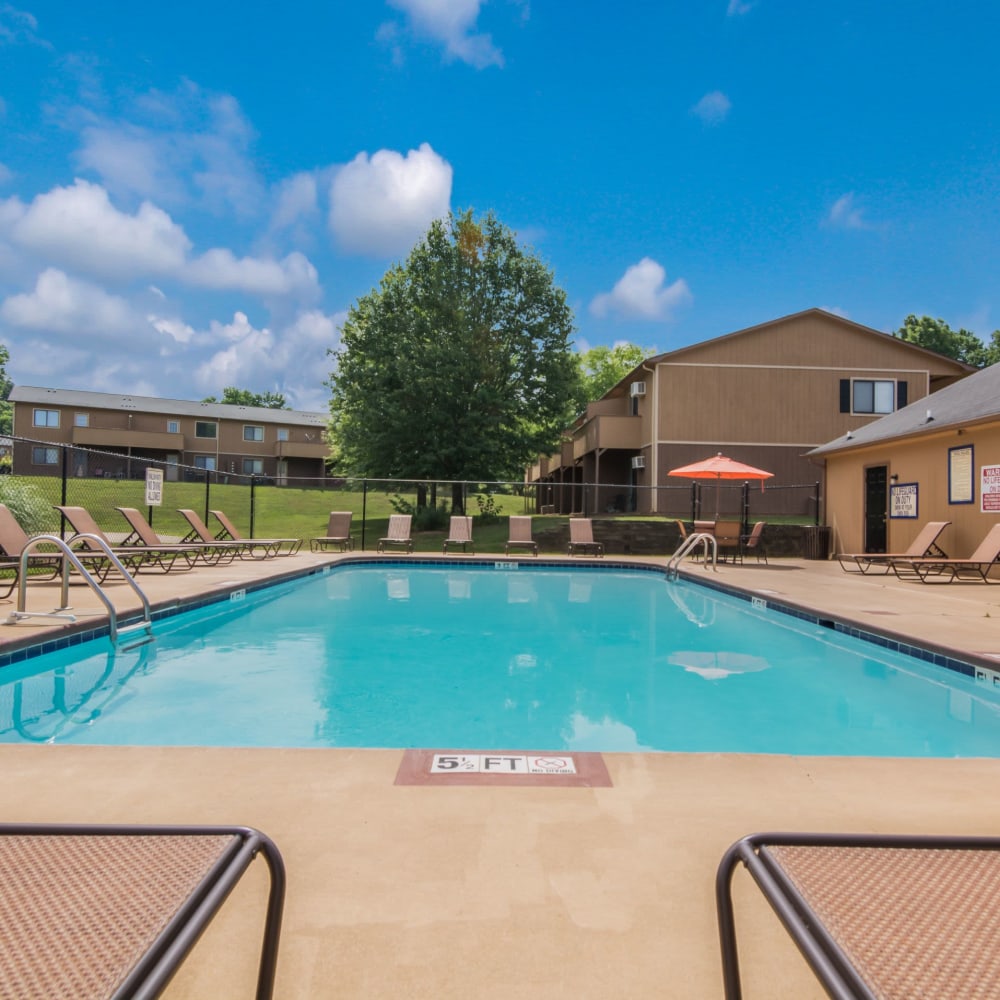 Swimming pool surrounded by lounge chairs at 1022 West Apartment Homes in Gaffney, South Carolina