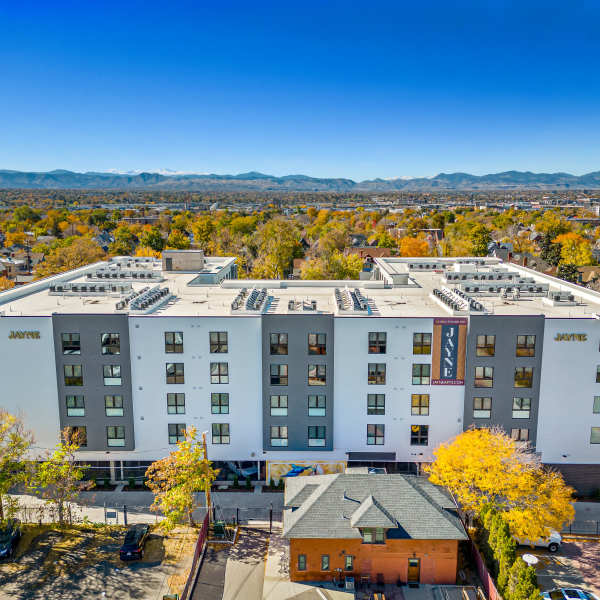 Exterior of apartment homes and surrounding city at Jayne in Denver, Colorado