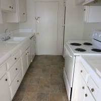 Apartment kitchen with white appliances at Regency in Sherman Oaks, California