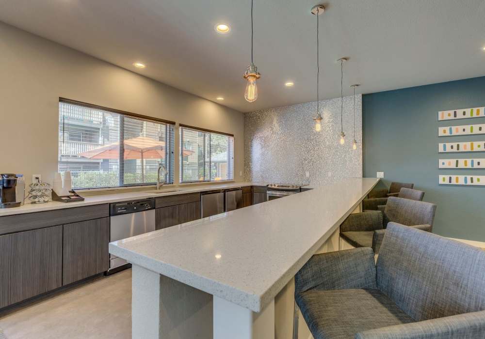 Clubhouse kitchen with quartz counters and bar seating at Foundry on Fifth in Renton, Washington