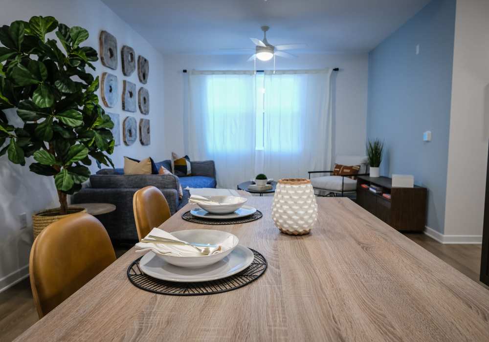 Dining table with chair and view to living room at The Courtyards Pacific Village in San Diego, California