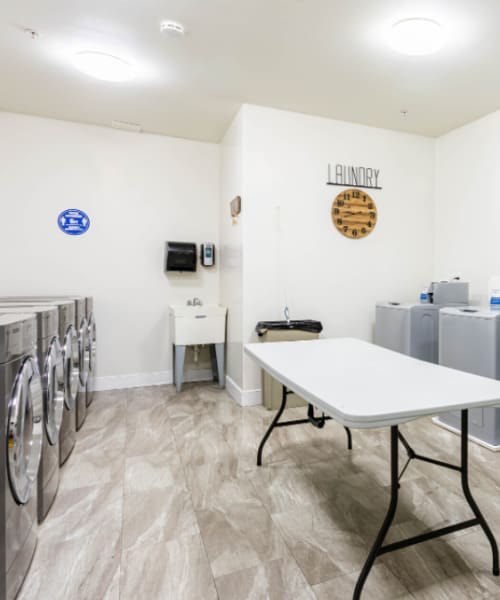 The community laundry room with washers and dryers at Grand Meridia Apartments in Rahway, New Jersey