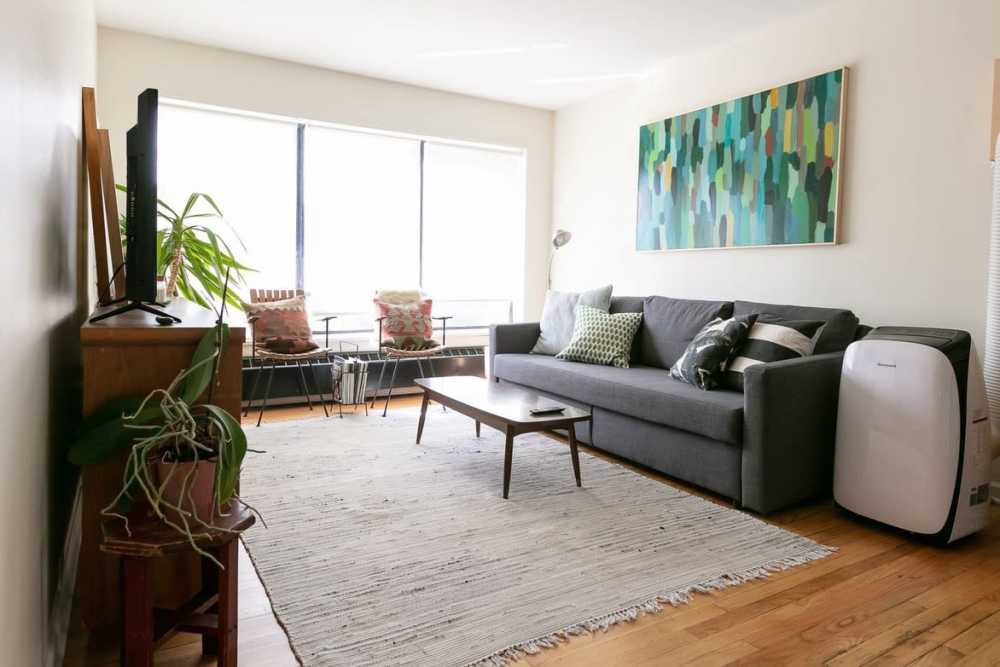 Open layout living room with couch at Detroit Living in Detroit, Michigan