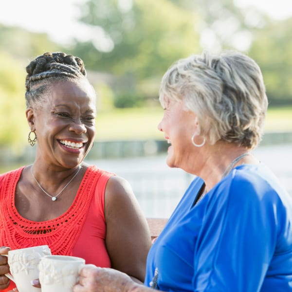 Two residents enjoying a cup of coffee at Pacifica Senior Living Forest Trace in Lauderhill, Florida