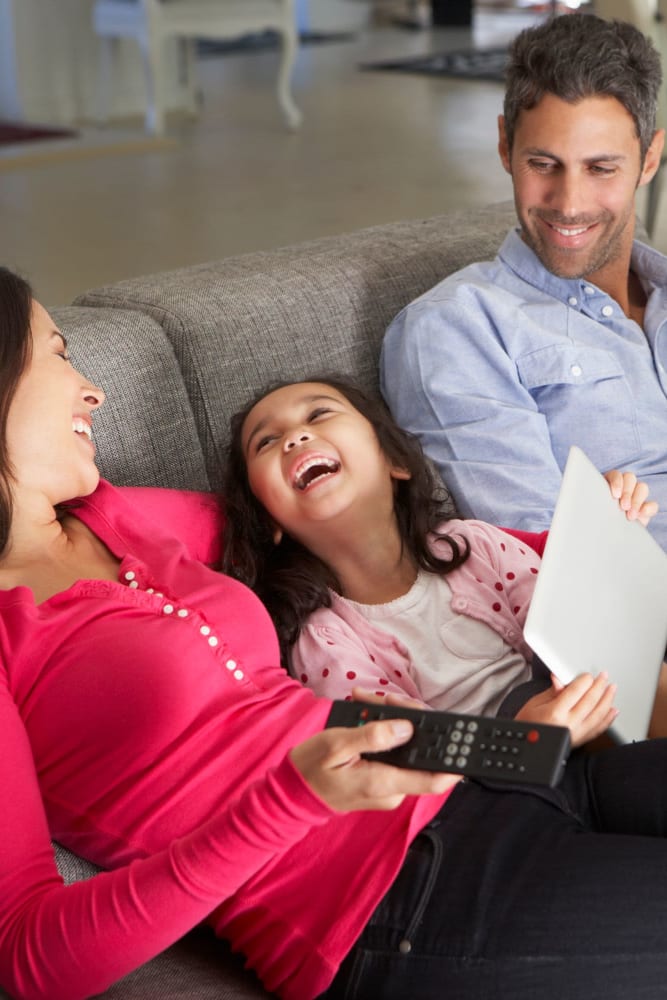 Resident family relaxing on their couch at The Armory in Bethlehem, Pennsylvania