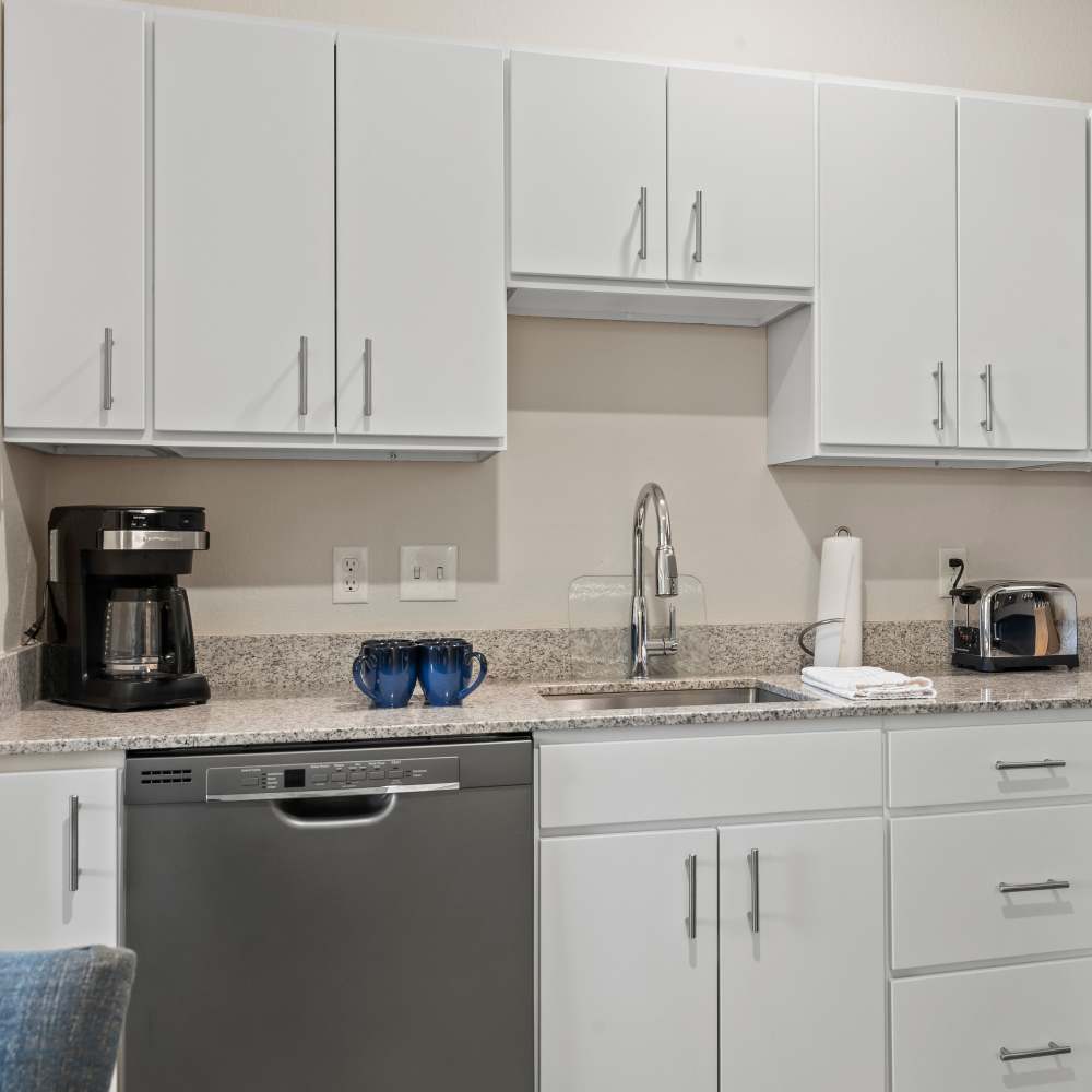 Kitchen with white appliances at WaterWalk Kansas City - Overland Park in Overland Park,Kansas
