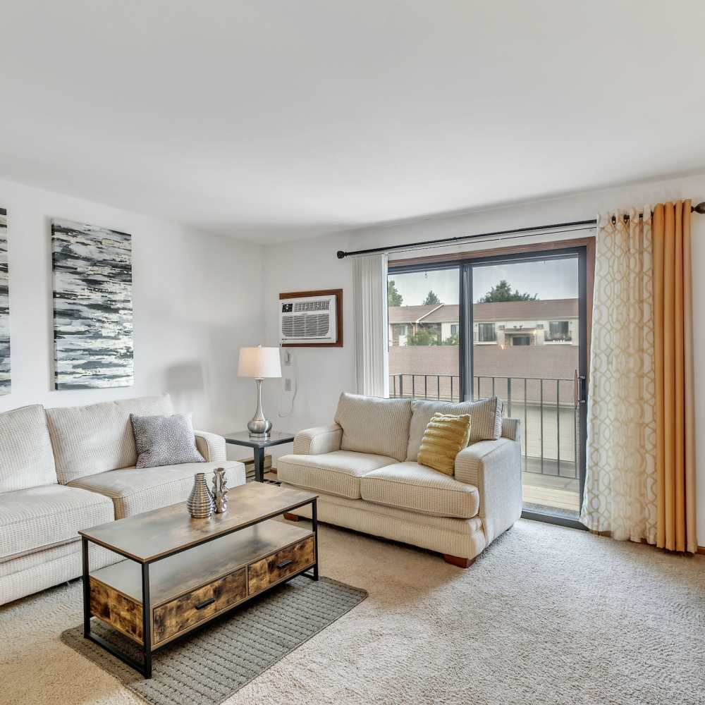 Bright living room with quality furniture and plush carpeting at Prairie Apartments in Salem,Wisconsin