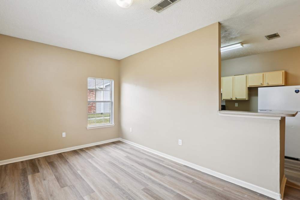 Unfurnished living room with view to kitchen at Camden Park in Canton, Mississippi