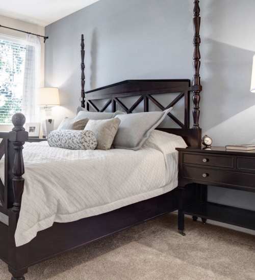 Spacious bedroom with large comfortable bed, desk, and large window at Rivers Edge in Lake Elsinore, California