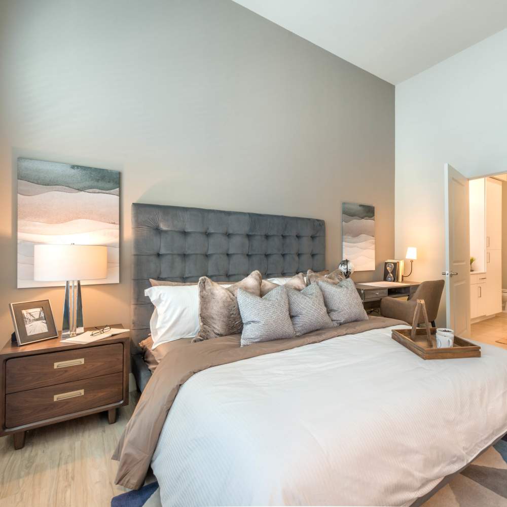 Well-furnished bedroom of an apartment home at Hall Street Flats in Dallas, Texas