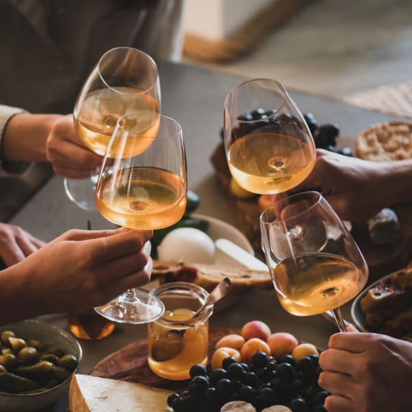 Friends celebrating with some wine near The Mallory in Raleigh, North Carolina