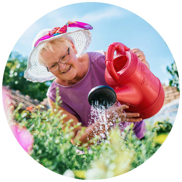 Resident watering flowers at Sawtooth Ridges Apartments