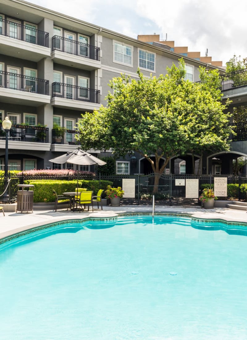 Swimming pool with sun chairs at Marquis at Tanglewood in Houston, Texas