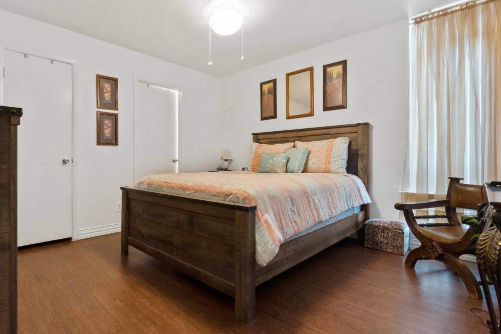 Spacious bedroom with decorative wall art at Woodland Village Apartments in Breckenridge, Texas