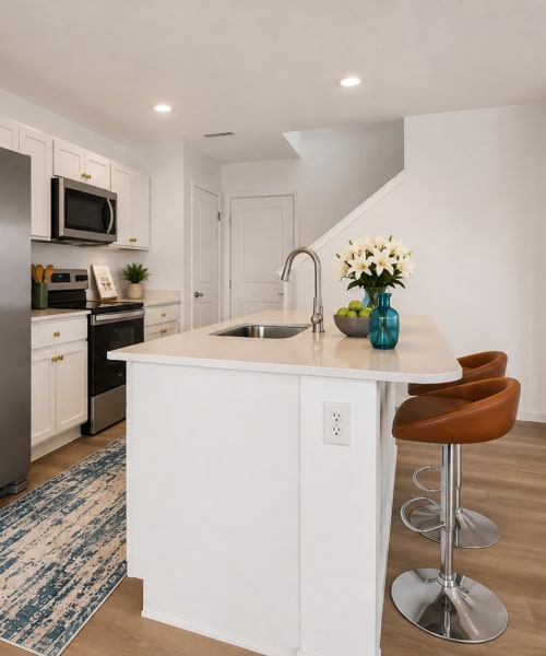 White kitchen cabinets and stainless steel appliances at Brixin Sonora in Fort Wayne, Indiana