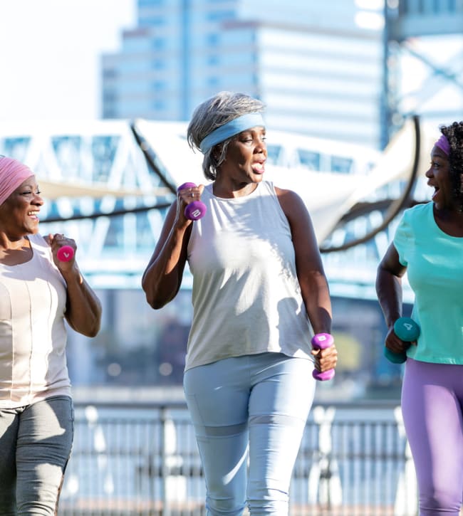 Three senior women on a walk near Greater New Hope Tower Apartments in Baltimore, Maryland