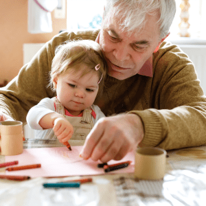 Resident painting with his young grandchild at Hanover Place in Tinley Park, Illinois