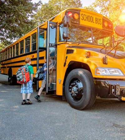 Kids boarding the school bus at Summers Run Apartments in Asheboro, North Carolina