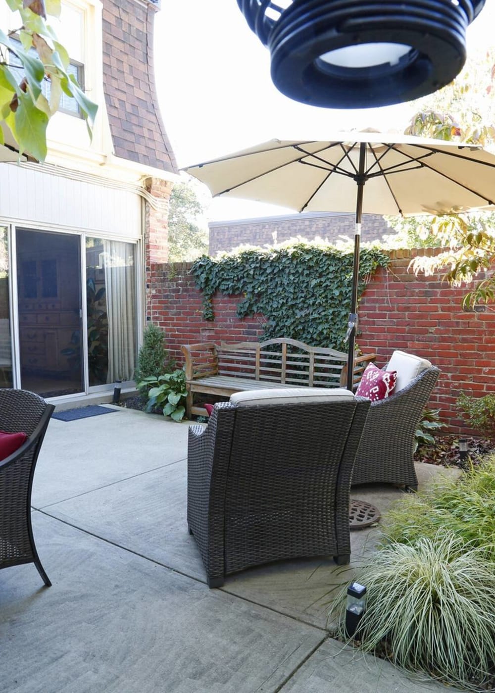 Patio area with chairs under an umbrella at River Oaks in Pittsburgh, Pennsylvania