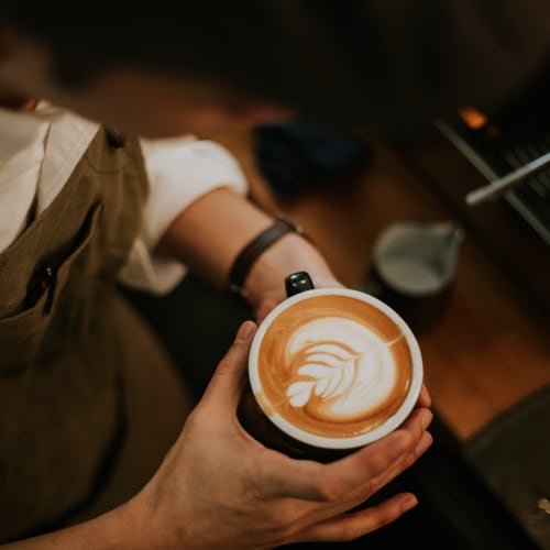 A cappuccino with rosetta latte art at a café near Strata Apartments in Denver, Colorado