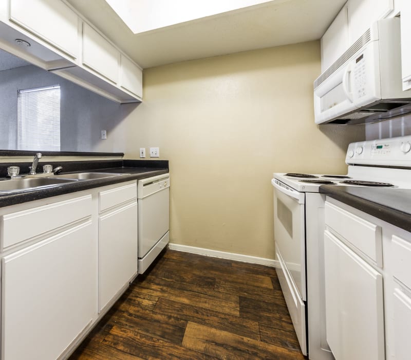 Kitchen with white appliances and cabinetry at SoCo on The Lake in Austin, Texas