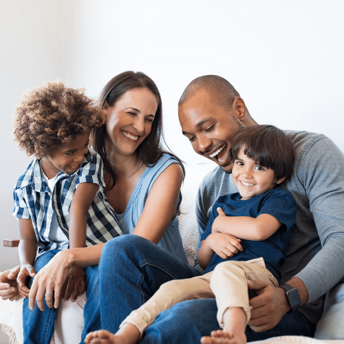 A family on a couch at Liberty Military Housing in Newport Beach, California