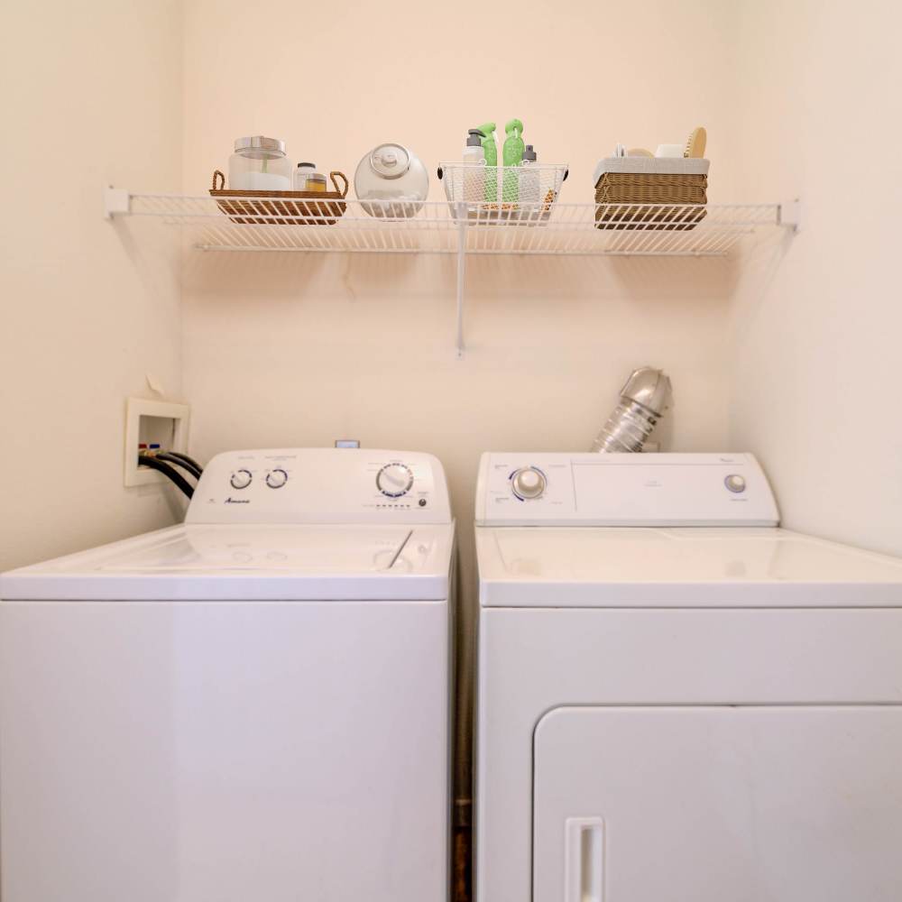 Charming laundry area with modern appliances and organized storage at Boulder Springs in Maryland Heights, Missouri.