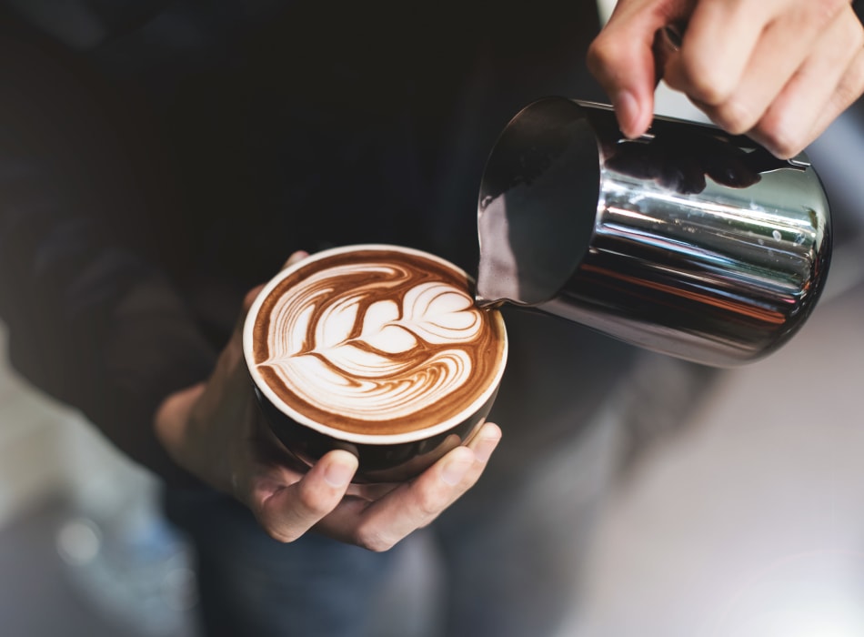 Barista making a latté for a customer near Sofi Waterford Park in San Jose, California