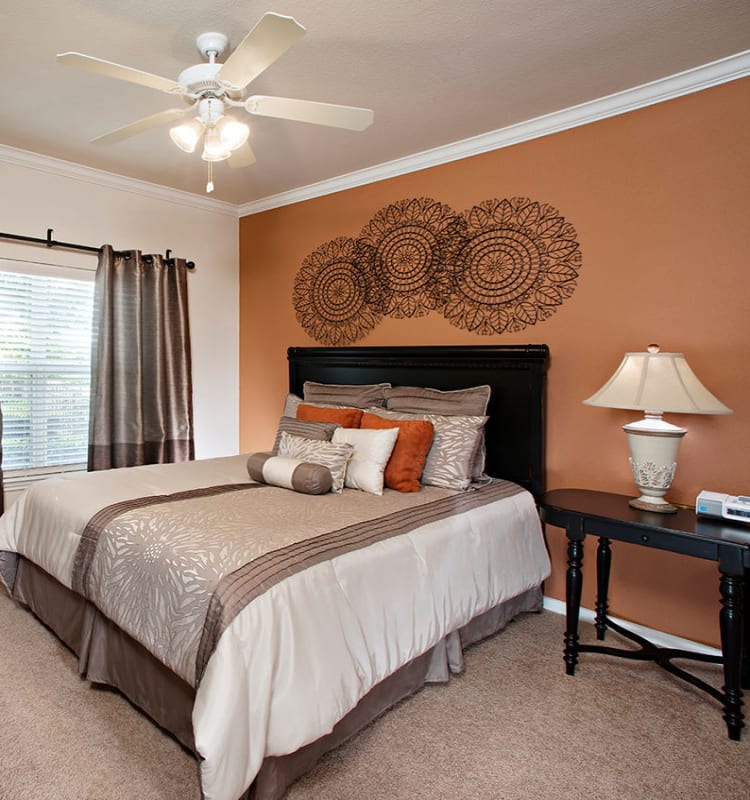 Model bedroom with a ceiling fan at Estancia at Ridgeview Ranch