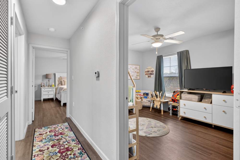 Charming bedroom with playful decor and inviting natural light at Lakewood Crossing in Granbury, Texas.